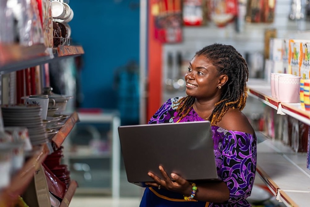 Shop owner taking stock on a laptop